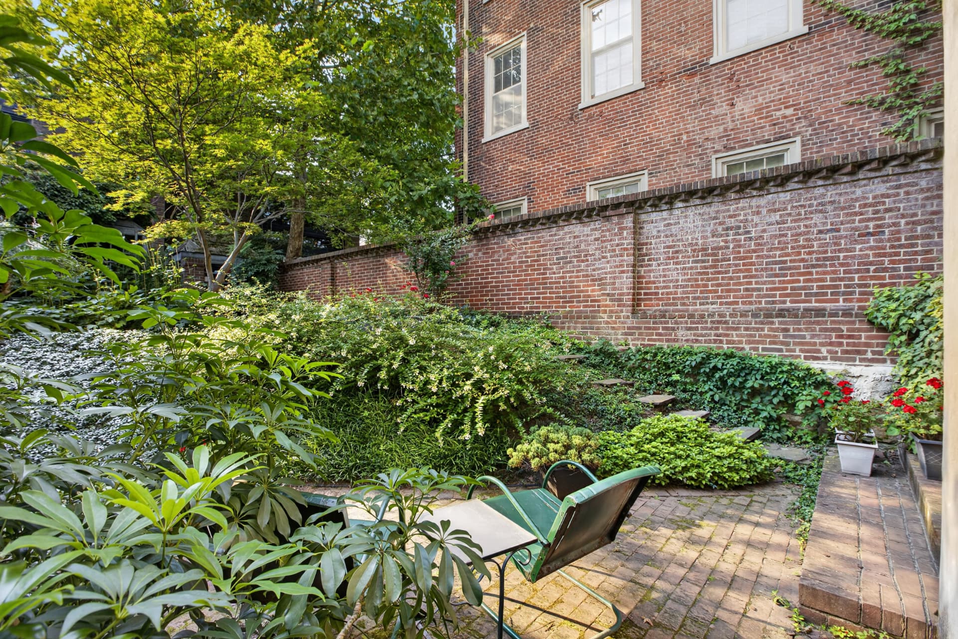 Terraced garden with mature plantings and brick walls at 234 S 3rd Street